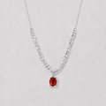 A delicate silver necklace featuring a textured, beaded chain and a central oval red agate pendant, displayed against a neutral light gray background.