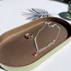 Jewelry set with silver red agate necklace and ring on a textured surface