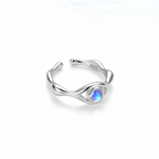 Silver ring with a moonstone on a white background side view