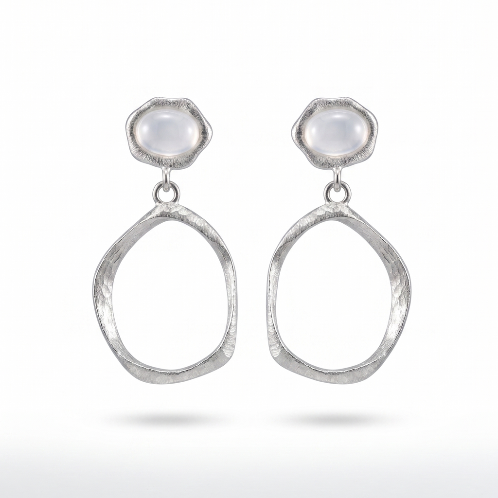Pair of silver earrings with teardrop shapes and white agate stones on a white background