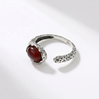Silver ring with a red agate on a white background side view