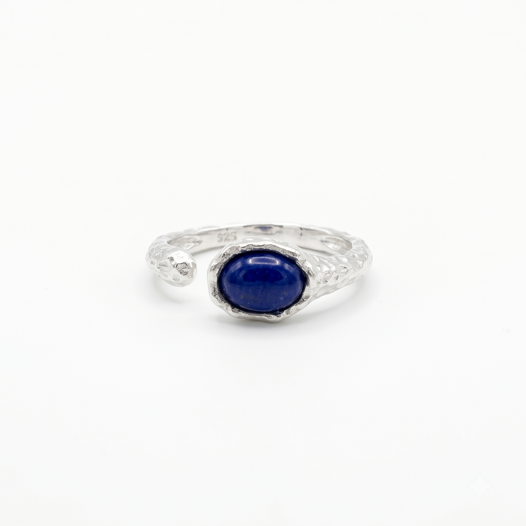 Silver ring with a blue gemstone on a white background