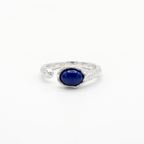 Silver ring with a blue gemstone on a white background