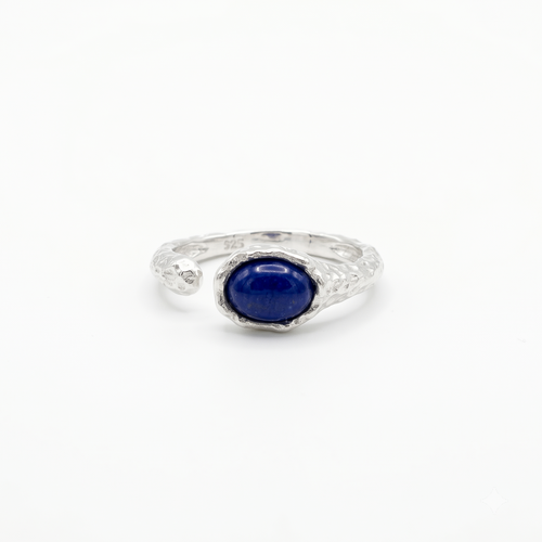 Silver ring with a blue gemstone on a white background