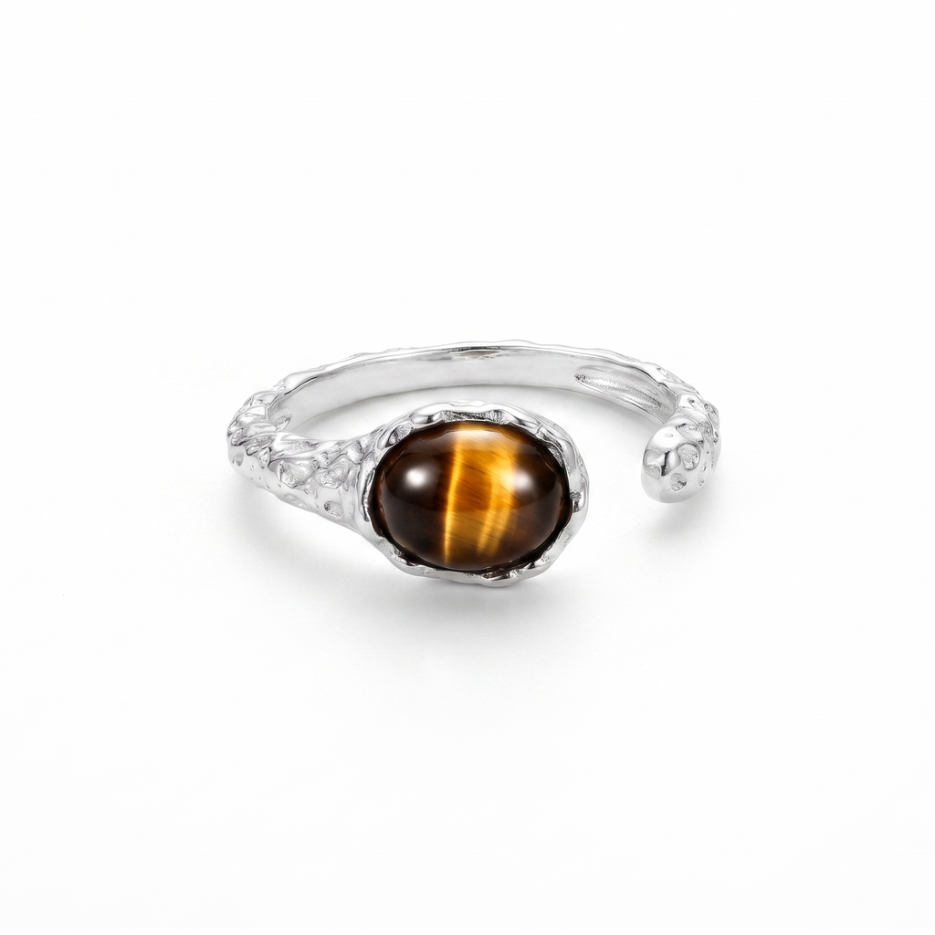 Silver ring with a tiger's eye stone on a white background
