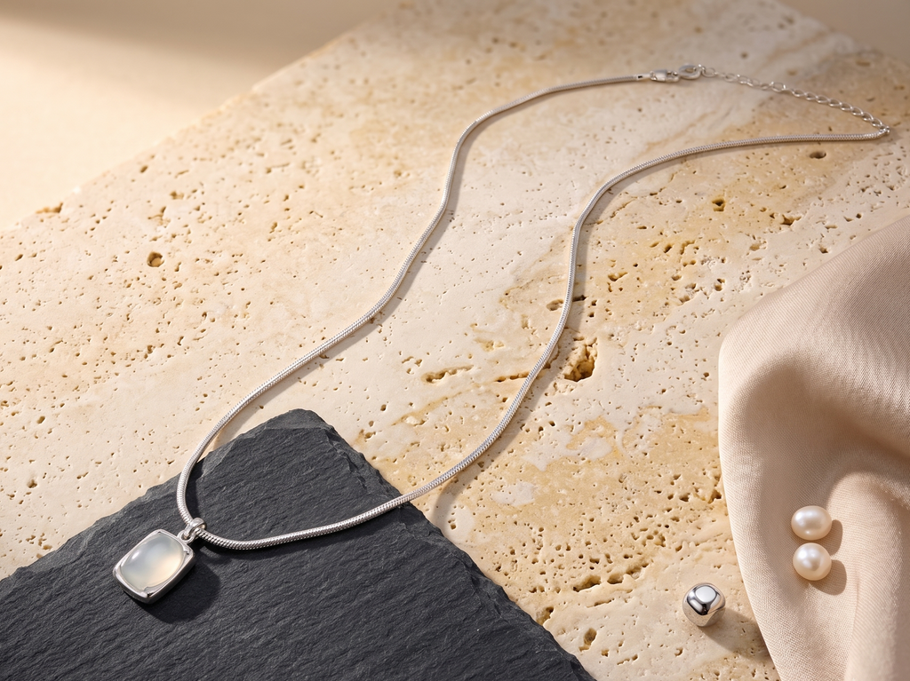 Necklace with a white agate pendant on a textured surface