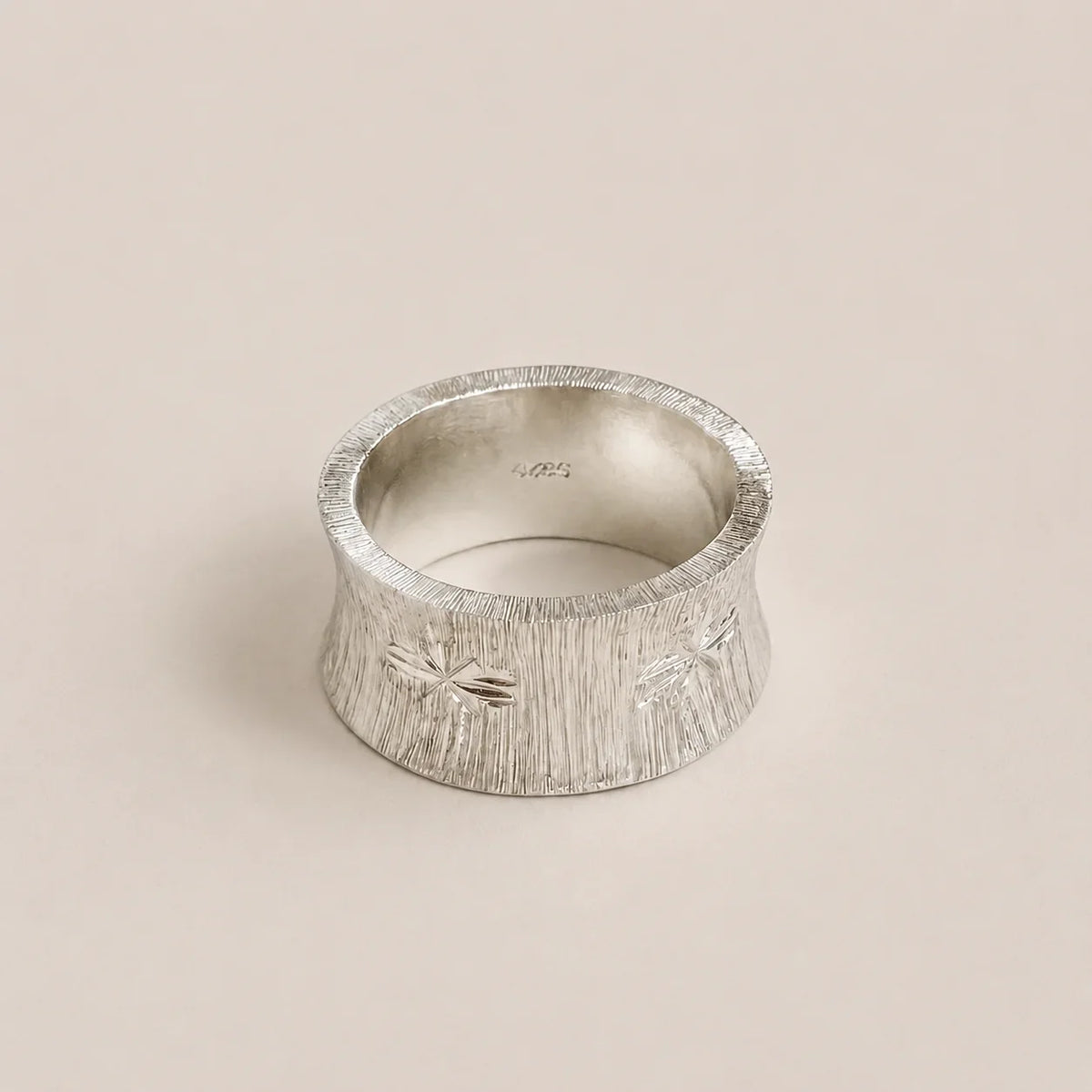 Textured 925 sterling silver band ring with engraved starburst details